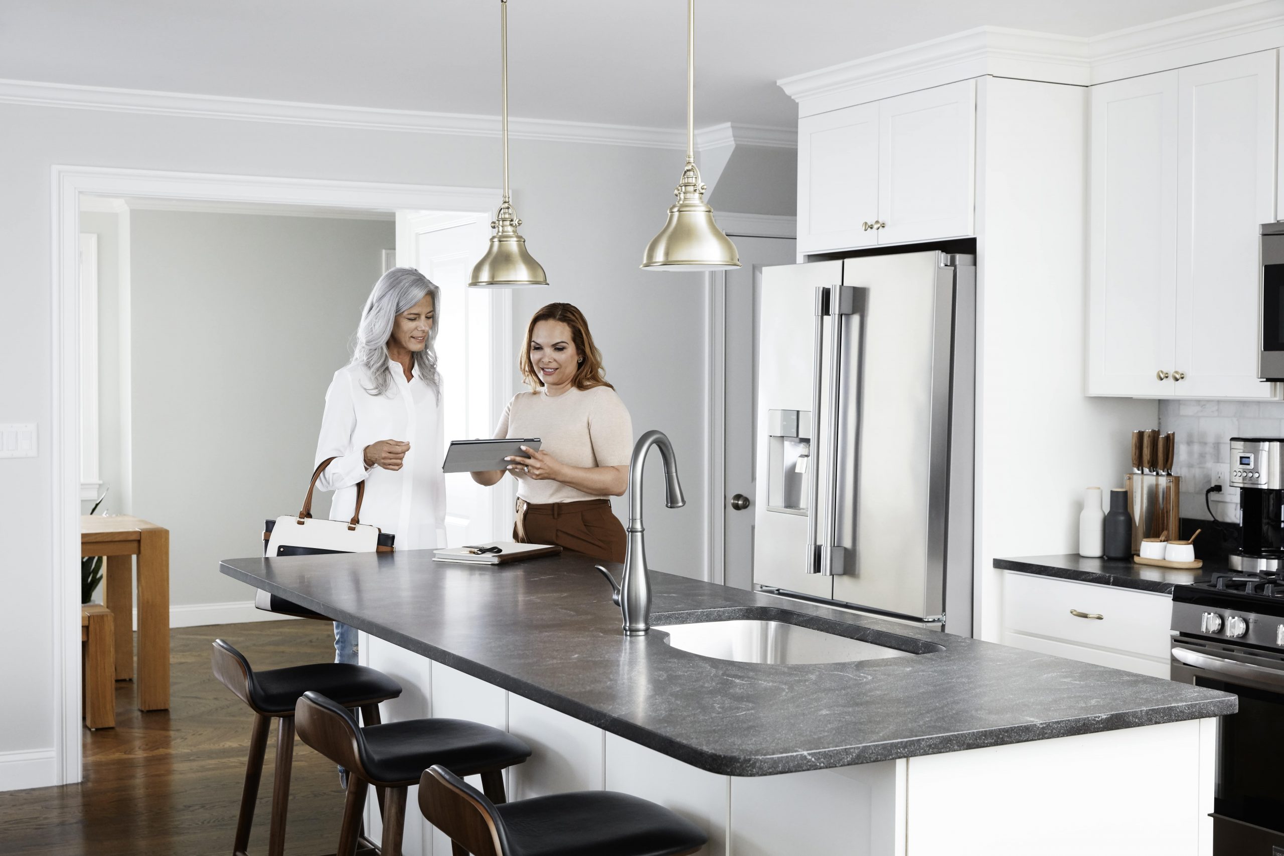 Agent speaking with client in kitchen